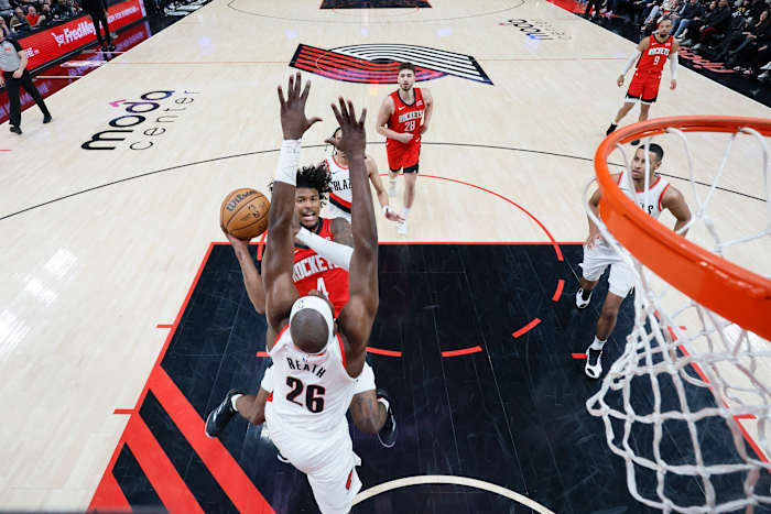 Rockets shooting guard Jalen Green (4) shoots the ball against Portland Trail Blazers center Duop Reath (26) during the first half at Moda Center.